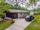Backyard view of a single-story home, with a screened porch and private driveway at 5207 Dixie Lake Rd, Union City, GA 30291