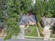 Aerial view of a well-maintained home with manicured lawn and mature trees at 569 Fairway Dr, Woodstock, GA 30189