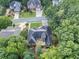 Aerial view of home showcasing rear deck and mature trees at 569 Fairway Dr, Woodstock, GA 30189