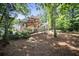 Picturesque backyard with mature trees and a view of the home at 569 Fairway Dr, Woodstock, GA 30189