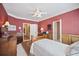 Comfortable bedroom with a ceiling fan and a classic wood trim design at 569 Fairway Dr, Woodstock, GA 30189