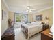 Bright bedroom with a ceiling fan, window seat, and a view of the outdoors at 569 Fairway Dr, Woodstock, GA 30189