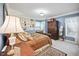 Cozy bedroom with blue walls, plush carpet, decorative lamps, and elegant furnishings at 569 Fairway Dr, Woodstock, GA 30189