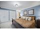 Comfortable bedroom with ample closet space, neutral carpet, and soft, warm lighting at 569 Fairway Dr, Woodstock, GA 30189