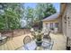 Inviting outdoor deck with seating, dining table, and wooded views at 569 Fairway Dr, Woodstock, GA 30189