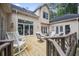 Inviting outdoor deck with seating, dining table, and wooded views at 569 Fairway Dr, Woodstock, GA 30189