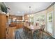 A sunny dining area with wood floors, a large window, and a view into the kitchen at 569 Fairway Dr, Woodstock, GA 30189