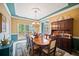 Elegant dining room featuring a decorative chandelier, wainscotting and a large wood table with seating for eight at 569 Fairway Dr, Woodstock, GA 30189