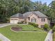 Beautiful brick house with well-maintained landscaping and an attached two-car garage at 569 Fairway Dr, Woodstock, GA 30189