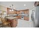 Well-lit kitchen with wood cabinets, granite countertops, and stainless steel appliances at 569 Fairway Dr, Woodstock, GA 30189