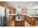 Spacious kitchen featuring granite countertops, stainless steel appliances, and wood cabinetry at 569 Fairway Dr, Woodstock, GA 30189
