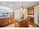 An eat-in kitchen with wooden cabinets, a center island, and an adjacent desk area at 569 Fairway Dr, Woodstock, GA 30189