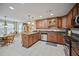 Spacious eat-in kitchen featuring wood cabinets, granite counters, and stainless steel appliances at 569 Fairway Dr, Woodstock, GA 30189