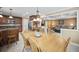 Eat-in kitchen open to living room featuring stainless appliances, wood cabinets and center island at 569 Fairway Dr, Woodstock, GA 30189