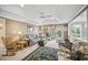 Bright living room with neutral walls, a patterned sofa, and access to a sunroom at 569 Fairway Dr, Woodstock, GA 30189