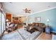 An open-concept living room, that flows to the dining area, and has wood floors and modern decor at 569 Fairway Dr, Woodstock, GA 30189