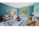 Comfortable living room featuring blue walls, a decorative rug, and a cozy seating area at 569 Fairway Dr, Woodstock, GA 30189