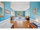 Bright living room with hardwood floors and blue walls with large window views to the exterior at 569 Fairway Dr, Woodstock, GA 30189
