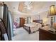 A luxurious main bedroom with a trey ceiling, neutral colors, and ample natural light at 569 Fairway Dr, Woodstock, GA 30189