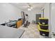 Organized storage room with shelving, desk, exercise equipment, and floor tiles at 569 Fairway Dr, Woodstock, GA 30189