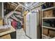 Basement utility room with exposed ductwork, water heater, and tiled floor at 569 Fairway Dr, Woodstock, GA 30189