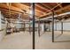 Unfinished basement space with exposed beams, concrete flooring, and ample room for storage at 1494 May Se Ave, Atlanta, GA 30316