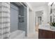 Bathroom featuring a shower with a stylish patterned curtain, blue tiling, and hexagonal tile flooring at 1494 May Se Ave, Atlanta, GA 30316