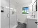 Modern bathroom with glass-enclosed shower, sleek vanity, and natural light from the window at 1494 May Se Ave, Atlanta, GA 30316