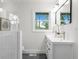 Bright bathroom with white vanity, modern fixtures, and a stylish mirror reflecting natural light at 1494 May Se Ave, Atlanta, GA 30316