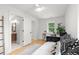 Light and airy bedroom with a view to the bathroom and desk, featuring hardwood floors and modern decor at 1494 May Se Ave, Atlanta, GA 30316
