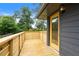 Stylish deck with wooden railings and a view of the backyard, accessible through a bright yellow door at 1494 May Se Ave, Atlanta, GA 30316