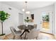 Cozy dining room with modern lighting, stylish decor, and a view of the outdoor deck at 1494 May Se Ave, Atlanta, GA 30316