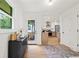 Bright foyer with dark furniture, hardwood floors, and an open doorway to the living space at 1494 May Se Ave, Atlanta, GA 30316
