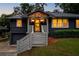 Exterior of a home showcasing dark gray brick, wood trim, an integrated garage, and steps to the door at 1494 May Se Ave, Atlanta, GA 30316