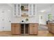 Stylish kitchen bar with custom cabinets, shelving, and a built-in wine refrigerator at 1494 May Se Ave, Atlanta, GA 30316