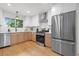 Well-lit kitchen with stainless steel appliances, bright tile backsplash, and modern fixtures at 1494 May Se Ave, Atlanta, GA 30316