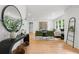Spacious living room featuring hardwood floors, two green chairs, a mirror, and a decorative plant at 1494 May Se Ave, Atlanta, GA 30316
