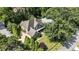 An aerial view of the home featuring a large yard, mature trees, and a well-manicured lawn at 157 Lake Forrest Ne Ln, Atlanta, GA 30342