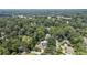 A far aerial view shows the location surrounded by lush and mature trees at 157 Lake Forrest Ne Ln, Atlanta, GA 30342
