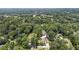 Lush green trees surround beautiful homes in this expansive aerial view of the residential area at 157 Lake Forrest Ne Ln, Atlanta, GA 30342
