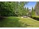 Lush green backyard showcasing a spacious lawn and a charming patio with comfortable seating, perfect for outdoor enjoyment at 157 Lake Forrest Ne Ln, Atlanta, GA 30342