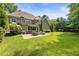 Expansive backyard with a well-manicured lawn and a patio area perfect for outdoor entertaining at 157 Lake Forrest Ne Ln, Atlanta, GA 30342