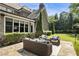 Charming outdoor patio with comfortable seating area, perfect for enjoying the serene backyard and manicured lawn at 157 Lake Forrest Ne Ln, Atlanta, GA 30342