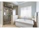Bright bathroom featuring a soaking tub and a glass walk-in shower at 157 Lake Forrest Ne Ln, Atlanta, GA 30342