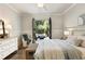 White Bedroom featuring hardwood floors and French doors to an outdoor sitting area at 157 Lake Forrest Ne Ln, Atlanta, GA 30342