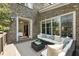 View of a brick patio and an outdoor seating area with plush cushions and throw pillows at 157 Lake Forrest Ne Ln, Atlanta, GA 30342