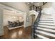 Elegant foyer with staircase and dining room featuring hardwood floors and chandeliers at 157 Lake Forrest Ne Ln, Atlanta, GA 30342