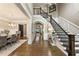 Elegant foyer with hardwood floors, a staircase with wrought iron railings, and a view of the dining room at 157 Lake Forrest Ne Ln, Atlanta, GA 30342