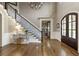 Spacious foyer with hardwood floors, staircase, and a view of a study or office, and a chandelier at 157 Lake Forrest Ne Ln, Atlanta, GA 30342