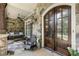Close-up of the inviting front porch with stone details, swing, and a beautiful wood front door at 157 Lake Forrest Ne Ln, Atlanta, GA 30342